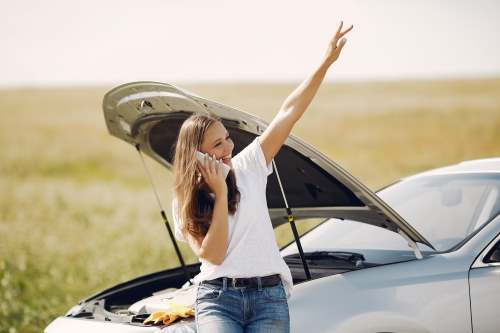 A lady hailing our roadside assistance team to help fix her car breakdown problem.