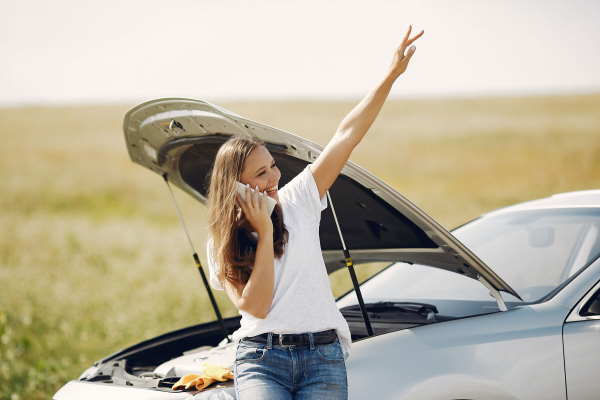 Girl calling roadside assistance with a broken down car in Townsville